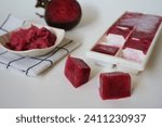 Small photo of Organic beetroot pulp juice fruits in ice cube trays ready for freezing. Can be used for face mask for healthy skin care., squeezed from a slow juicer, zero waste.