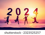 Small photo of Silhouette friends jumping and holding number 2024 on sunset sky abstract background at tropical beach. Happy new year and holiday celebration concept. Vintage tone color style.