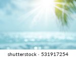 Blur beautiful nature green palm leaf on tropical beach with bokeh sun light wave abstract background. Copy space of summer vacation and business travel concept. Vintage tone filter color style.