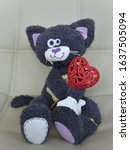 Funny plush cat sitting on a...
