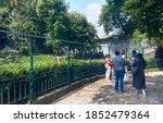 Small photo of Kolkata, 10/11/2020: A family watching a white tiger kept inside an open air enclosure. Alipore Zoo recently opened after long days of closure due to covid-19, but few people are coming till now.