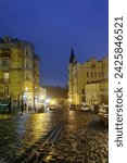 Small photo of KYIV, KIEV, UKRAINE - February 15, 2020: Evening view of St. Andrew's Descent in the Podolsky district of Kyiv. Street St. Andrew's descent - the historical part of Kiev Natural fog, romantic mood.