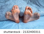 Small photo of Woman suffering from foot cramps, leg cramps or muscular spasm while sleeping. Feet pain or feet ache at night. Restless legs syndrome