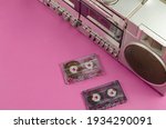 Small photo of Boombox Stereo Radio Cassette Recorder and random cassettes on pink background. Vintage Cassette Deck, retro technology, selective focus.