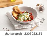 Small photo of Portion of gourmet breakfast with poached eggs and tomatoes