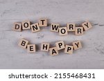 wooden blocks building the word DONT WORRY BE HAPPY