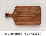 Walnut handmade wood cutting board on the linen