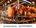 Small photo of Roast goose with crispy skin, a famous Dish of Cantonese cuisine in China. Roast goose with charcoal fire, the meat of goose is crisp and delicious.