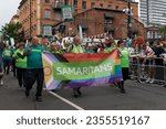 Small photo of Manchester UK. August 26, 2023. Manchester Pride parade. Samaritans walking in parade with New Union pub in background. Theme Queerly Beloved.