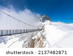 Austrias highest suspension bridge in the austrian Alps. Skywalk on Dachstein. Schladming, Styria, Austria 
Spectacular winter landscape and breathtaking views.