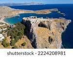 Small photo of Aerial view of the famouse tourist destination in rhodes island. Village Lindos, with the acropolis and the aegan sea. Dodecanese, Greece.