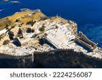 Small photo of Aerial view of the famouse tourist destination in rhodes island. Village Lindos, with the acropolis and the aegan sea. Dodecanese, Greece.