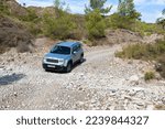Small photo of Vacation with a rental car. 4x4 off-road Jeep Renegade on dirt road on Rhodes island, Greece. October 09, 2022