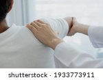 Small photo of Female physiotherapists provide physical assistance to male patients with shoulder injuries massage their shoulders for muscle recovery in the rehabilitation center. Physiotherapy concepts.