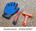 Small photo of dogs grooming tools (grooming mitt, comb and slicker brush)