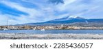 Small photo of View of Etna volcano from Riposto seaport in Sicily with historic building of town and Duomo church.Taken 2 April 2023 Riposto seaport