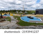 Small photo of Sudbury, Ontario, Canada -2022: Playground at Dynamic Earth science museum. Outdoor science center. Canadian nickel refinery chimney, superstack. View of the INCO mining and smelting complex.