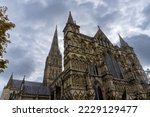 Small photo of Western front of Salisbury Cathedral in England. Statues of angels, Old Testament patriarchs, apostles, evangelists, martyrs, doctors, philosophers, royalty, priests and worthy people. Tallest spire.