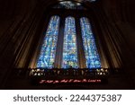 Small photo of Liverpool, United Kingdom -2022: Liverpool Cathedral's west window with Benedicite window by Carl Johannes Edwards. For You pink neon sign by Tracey Emin reads "I felt you and I knew you loved me"