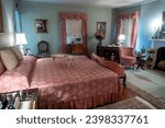 Small photo of Gettysburg, Pennsylvania -Aug 1, 2023: Eisenhower National Historic Site, home and farm of president Dwight D. Eisenhower. Mamie's bedroom with bed, bed tray, Ike's West Point photo