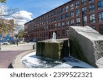 Small photo of Lowell, Massachusetts -Aug 1, 2023: Lowell National Historical Park celebrates the era of textile manufacturing during the Industrial Revolution. Mack Plaza, Market Mills, and murals.