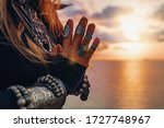 close up of woman hands. tribal style woman on the beach at sunset