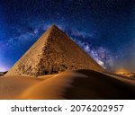 Pyramid of Khafre in desert dunes at night against the stars and Milky Way Galaxy. Giza, Egypt. Astrophotography, fantastic background
