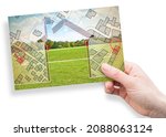 Small photo of Land plot management - Imaginary city map with buildings, land parcels and home silhouette - real estate concept with a vacant land on a green field available for building construction