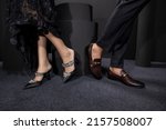 The girl and boy are standing on both, both have applied with your foot black stool, and has been placed on a foot below ground, girl wearing the Black net frock black high heel,boy black pent shirt.