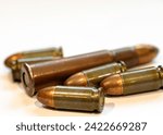 photograph of fired bullets and cartridges, white background