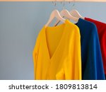 Colourful women’s cardigans hanging on a clothes rail