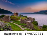 Small photo of Urquhart Castle at sunset located on the banks of Loch ness, Scotland.