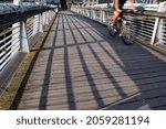 Small photo of Cork City, Cork, Ireland: July 31, 2021: A man riding a bike on abridge over River Lee, in Cork City