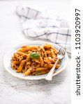 Small photo of Italian food and pasta pene with bolognese sause on plate.