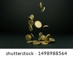 Falling one and two British pound coins on a black background 