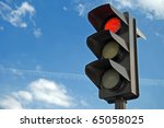Red color on the traffic light with a beautiful blue sky in background