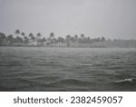 Small photo of On a rainy day in a boat midway on the backwaters of Kerala