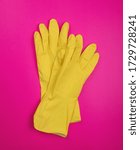 Small photo of color rubber gloves for cleaning on color background, workhouse concept. General or regular cleanup. yellow rubber gloves on background . Cleaning service