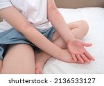 Small photo of The child scratches atopic skin. Dermatitis, diathesis, allergy on the child's body.