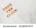 Top view of Cost Per Click word on wooden cube letter block on white background. Business concept