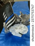 Small photo of Police officers memorial day images with blue roses bugle bell flag