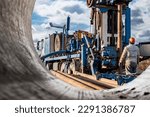 Pipes for a well close-up. Powerful drilling rig against a cloudy sky. Drilling of deep wells. Drilling equipment. Mineral exploration. Extraction of gas and oil