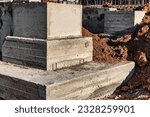 Monolithic reinforced concrete foundation for the construction of a residential building. Rostverk at the construction site. Construction pit with foundation after formwork removal