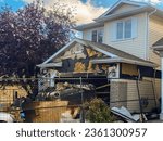 Small photo of Calgary, Alberta, Canada. Sep `12, 2023. A close-up view of a neighborhood garage roof, which bears the scars of recent accidental fire damage, expertly extinguished by firefighters.