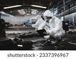 Small photo of Scientist workers wear protection suit checking chemical contaminated oil in old factory. Protecting Against Hazards and Contamination. Emergency Response to a Radioactive Accident.