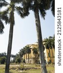 Small photo of HAZARDUARI, MURSHIDABAD, WEST BENGAL, INDIA on 12th. February 2022 ai 13:05 pm. Side view from garden foreground of Hazarduari Palace Museum Gate founded by Nawab Nazim Humayun Jah.