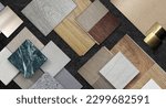 Small photo of home interior material samples selection contains brushed stainless, metallic laminated, wooden vinyl flooring tiles, laminated tiles, marble stone, stone tiles placed black stone table background.