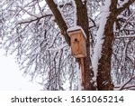 Wooden Birdhouse Hanging On...