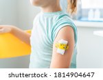Small photo of Vaccination of little girl in doctor's office.Kids funny adhesive plaster,gauze napkin.Sits on chair.Vaccine for covid-19 coronavirus,flu,infectious diseases.Injection.Clinical trials for human,child.