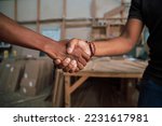 Adult men shacking hands in business workshop